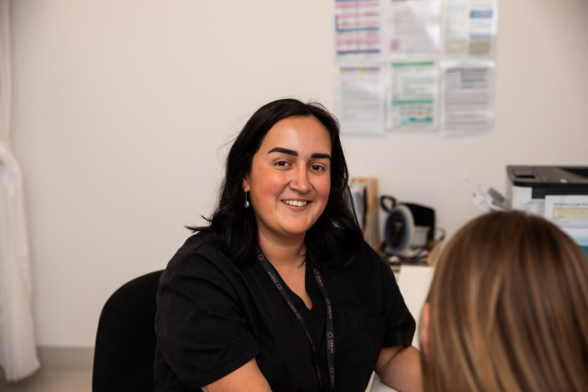 Clinician in consult room with patient smiling at the camera
